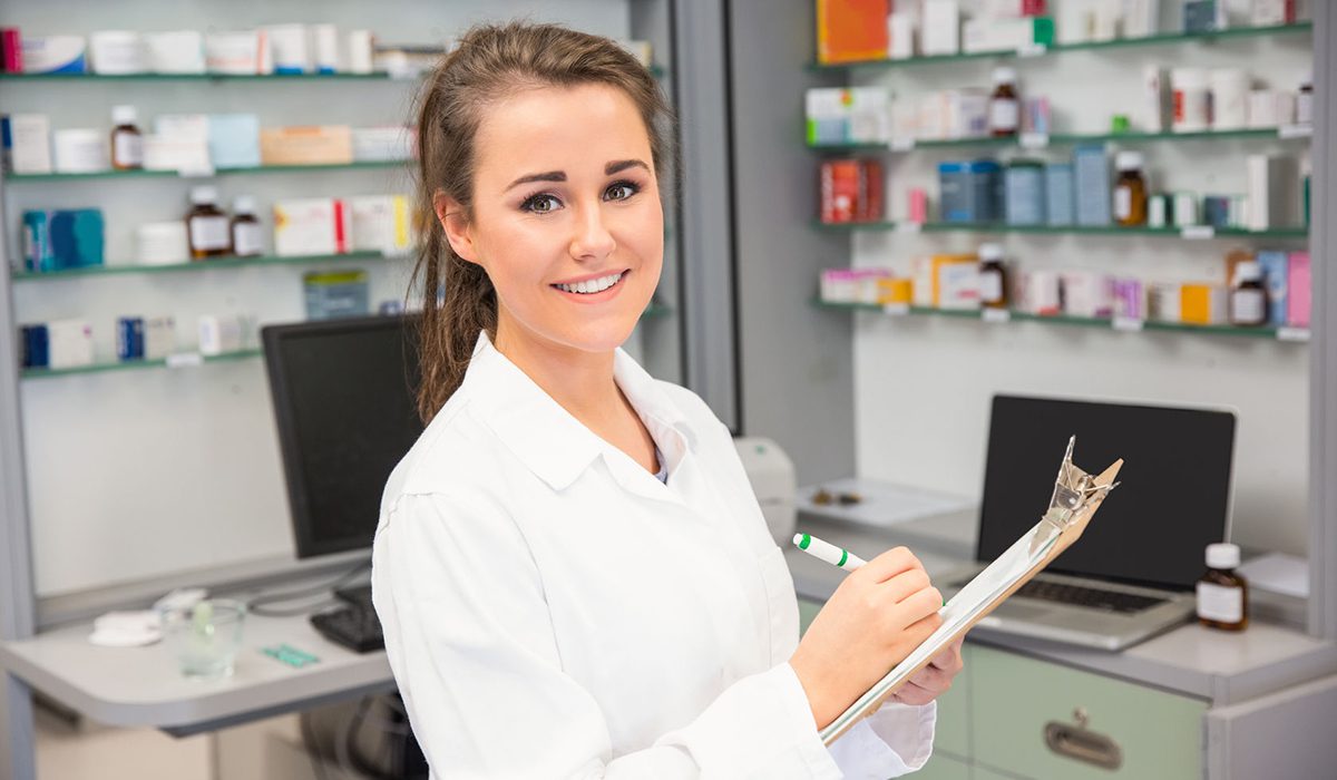 A woman in white lab coat holding papers.